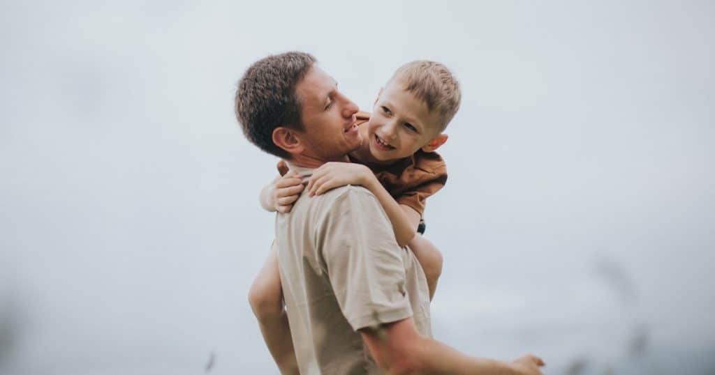 A boy hugging his dad https://www.autismparentingmagazine.com/autism-and-hugging/