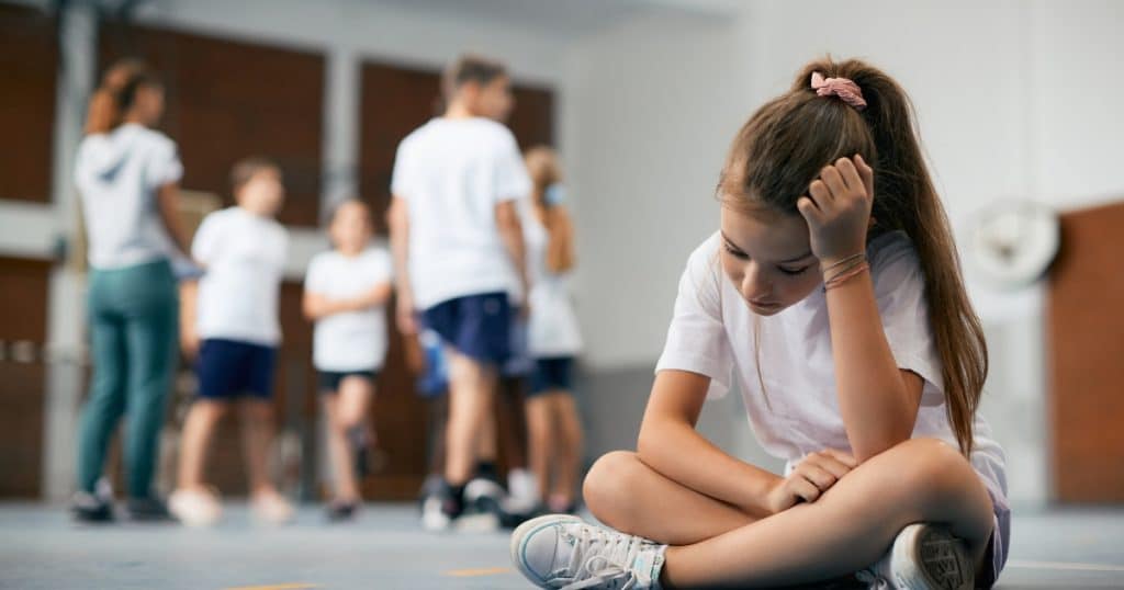 Girl feeling left out in school https://www.autismparentingmagazine.com/effects-of-masking-autism/