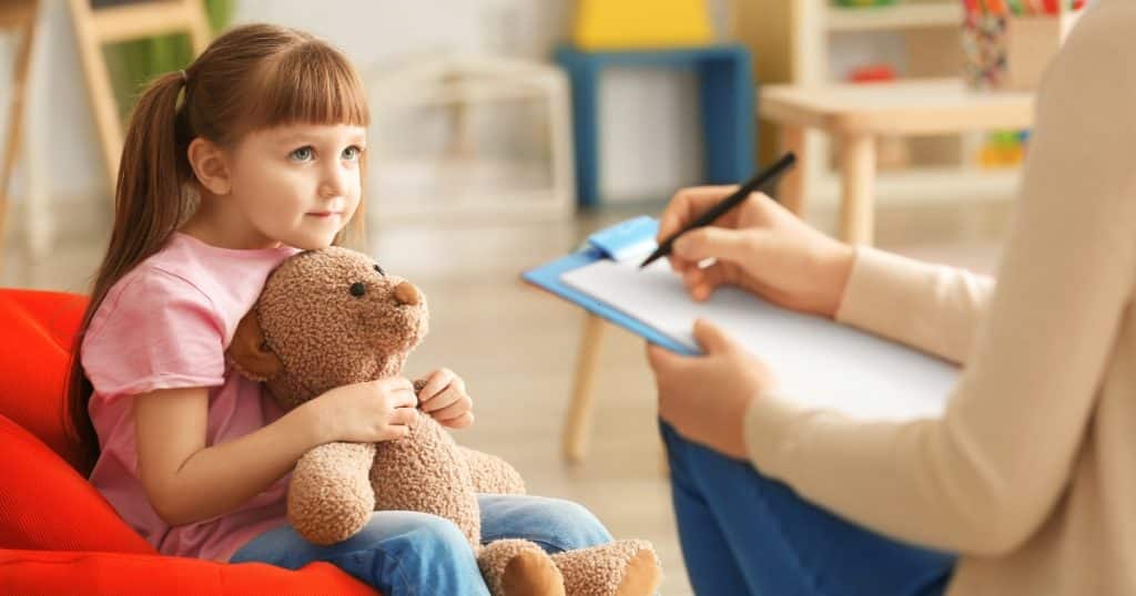 What to do if your child scores high A little girl talking to a therapist https://www.autismparentingmagazine.com/childhood-autism-rating-scale/