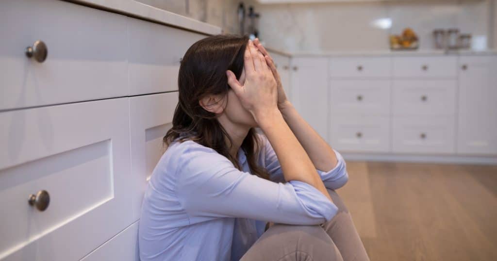 Autistic meltdowns in female adults Woman covering her face https://www.autismparentingmagazine.com/autistic-meltdowns-in-adults/
