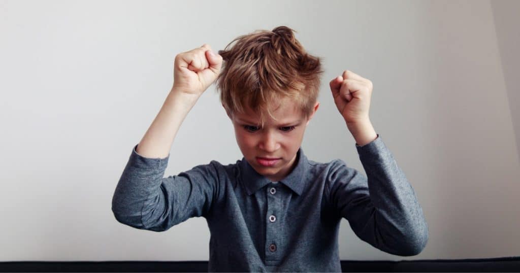 An angry boy with his fists in the air https://www.autismparentingmagazine.com/pda-vs-odd/