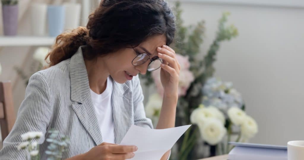 Woman in denial holding a paper https://www.autismparentingmagazine.com/autism-denial/